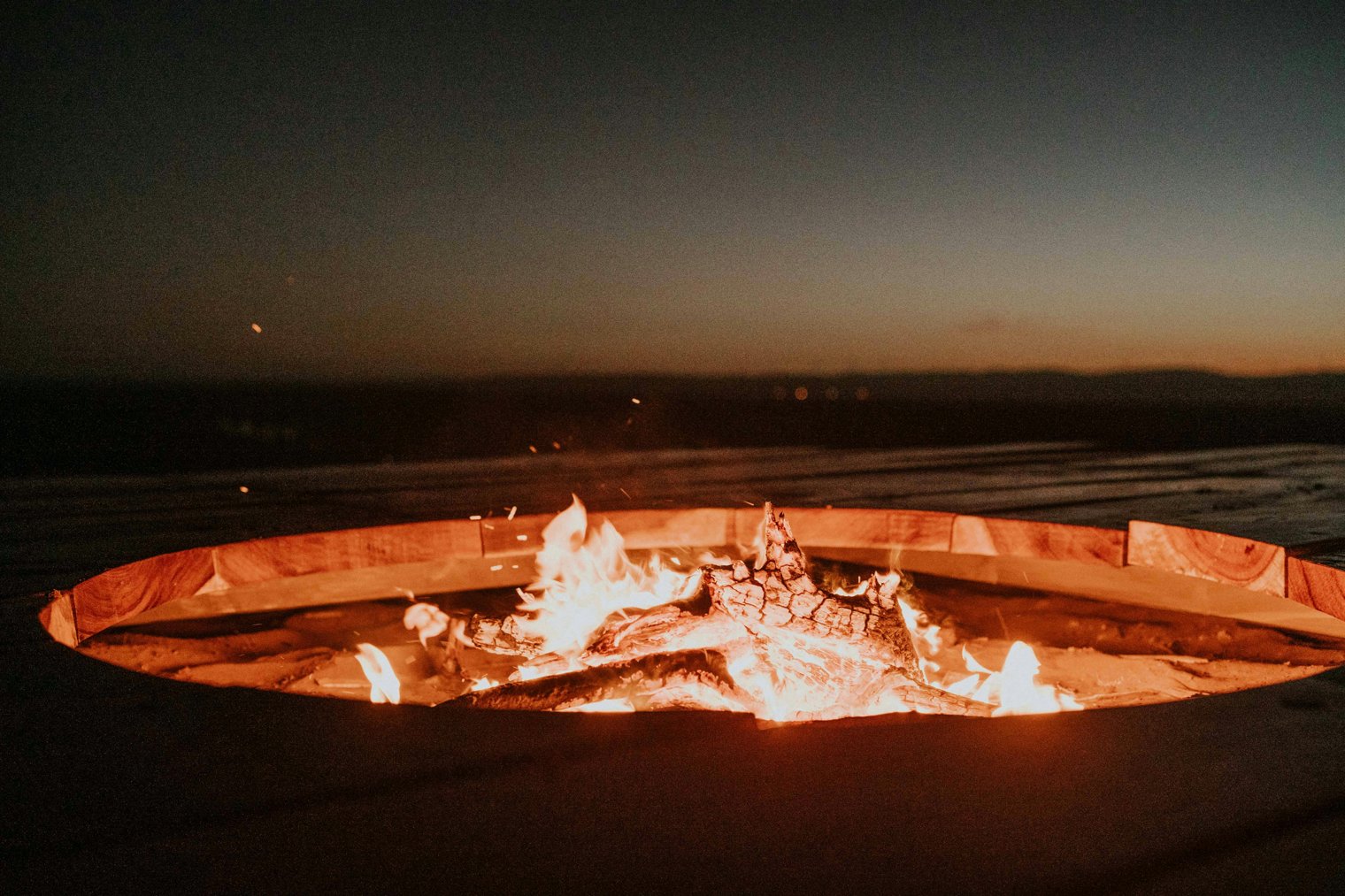 Sitting by a Fire Pit on a Cool Evening, Watching the Flames Dance and Crackle