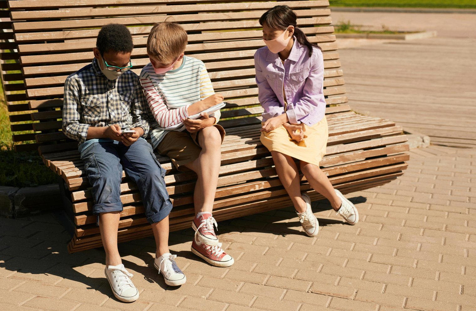 Sitting on a Bench at a Park, Watching Children Play in the Distance