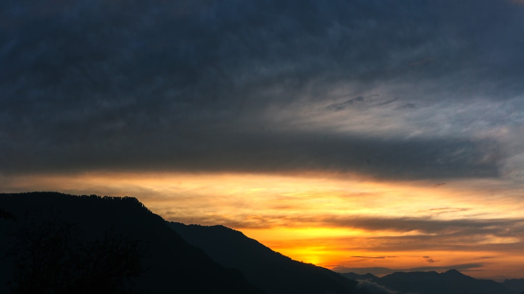 Sitting on a Hill Overlooking a Valley, Watching the Sun Rise Over the Mountains